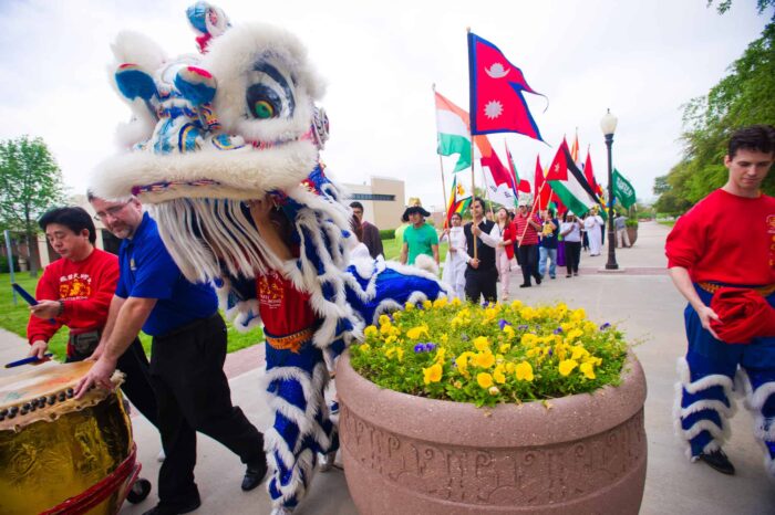 A group of individuals from different cultures in a parade.