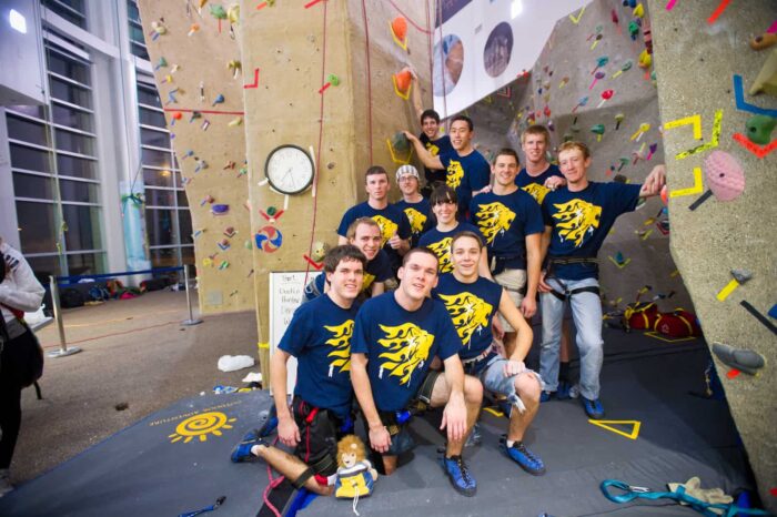 twelve students background 'climbing wall'