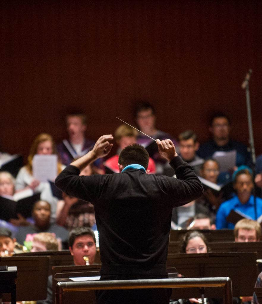 Composer directing a choir.