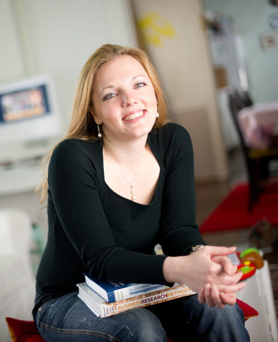 Social worker with books on a couch.