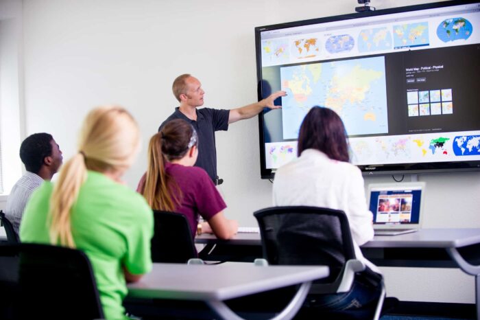 a professor showing something on a monitor during class