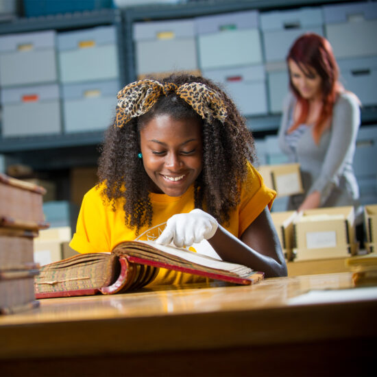 History student examine historical book.