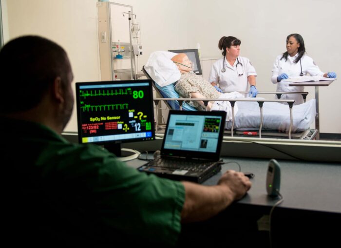 Two student nurses checking vitals for an assignment