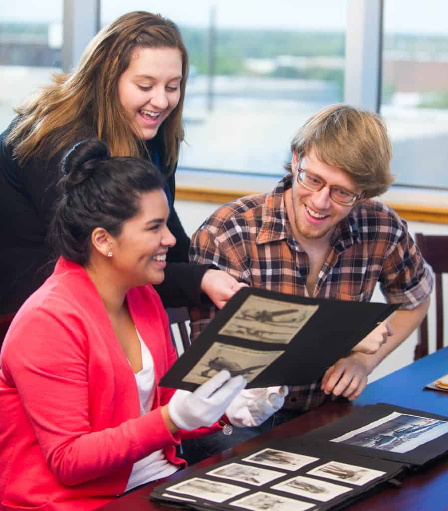 Students looking at historic photographs.