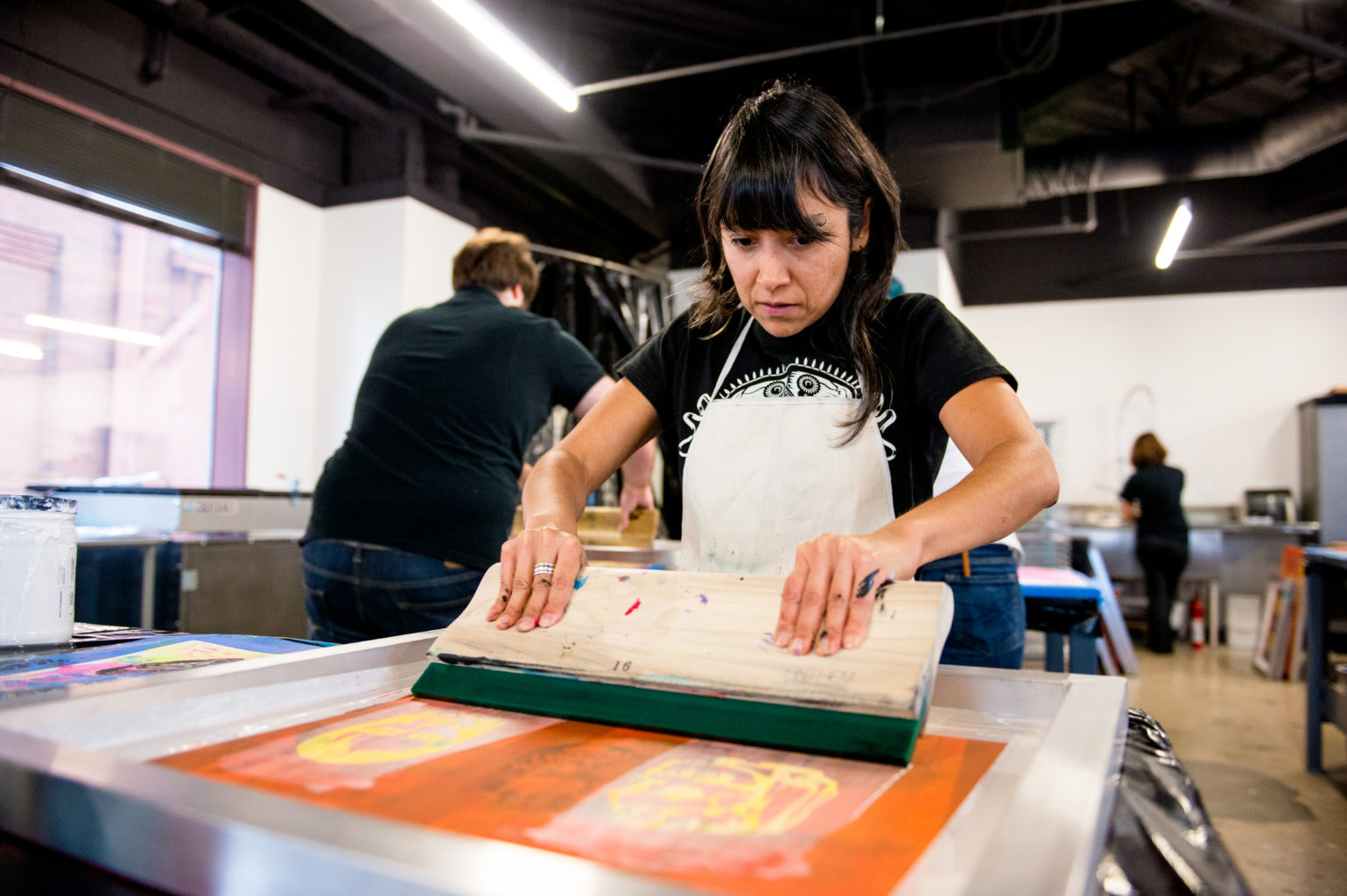 woman screen printing manually