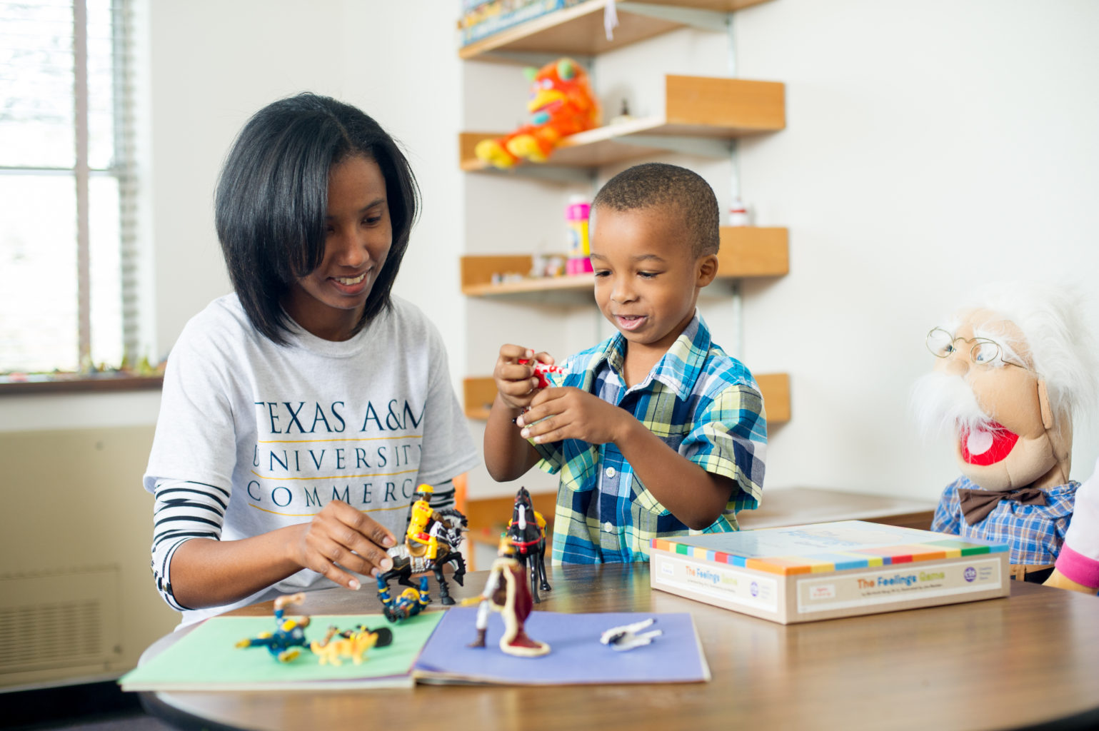 Social worker playing with a child.