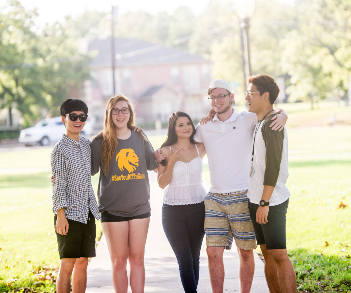 English students standing together on campus.