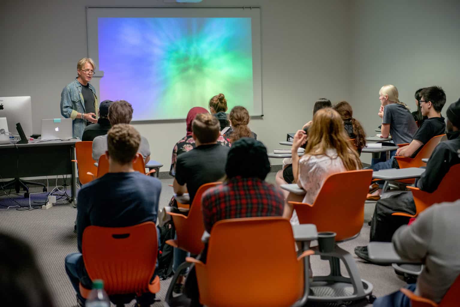 students in classroom listening to professor.