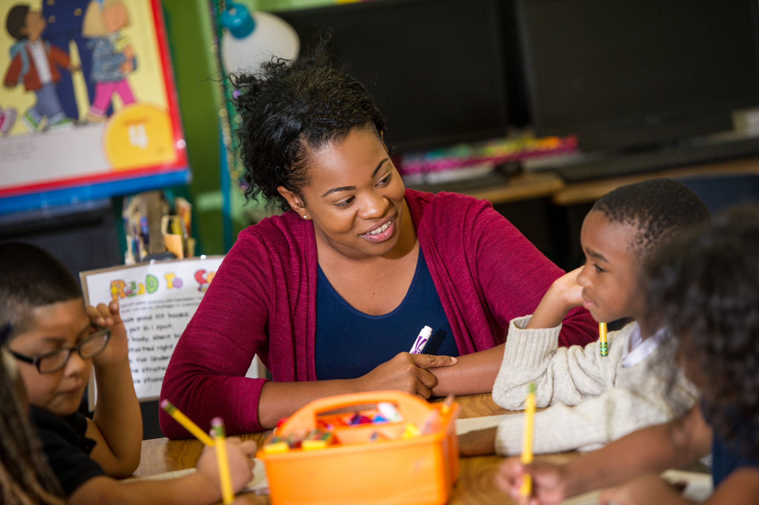 Female woman teaching young boy.