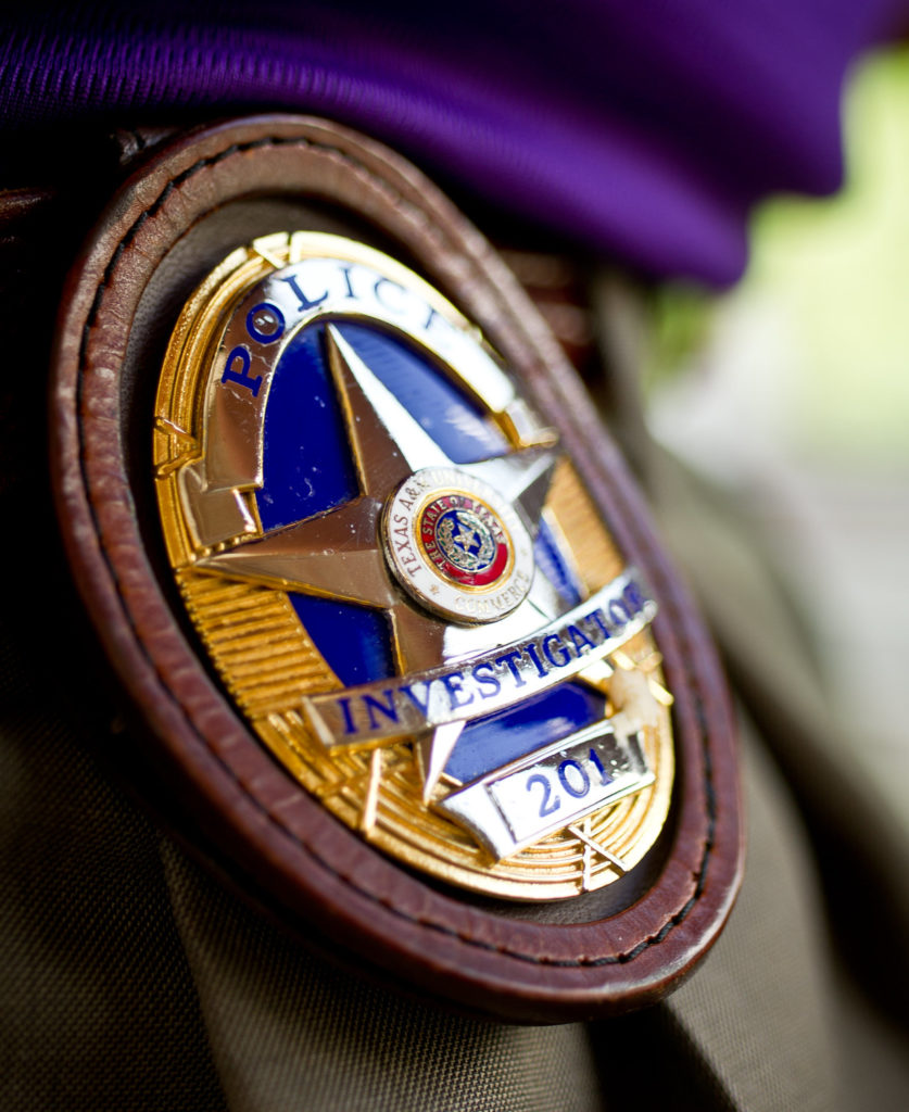 Police officer badge on a belt.