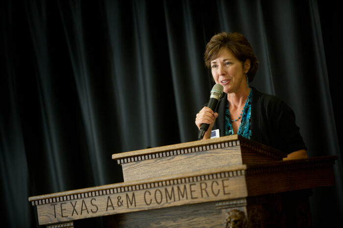 Woman teaching at a social work gala.