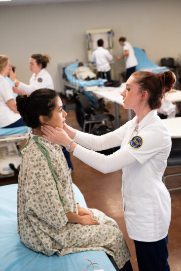 Nurse checking over a test patient.