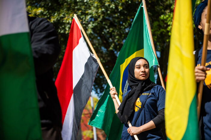 Female student holding a flag during the global cultural festival.