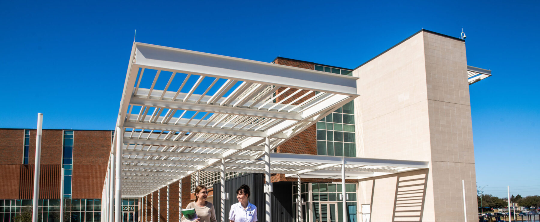 Students departing nursing and health sciences building.