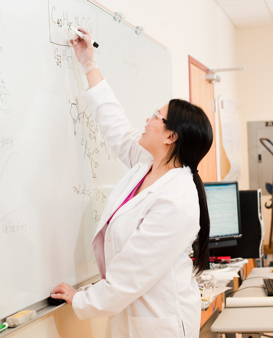 Nursing students solving a problem on a white board.