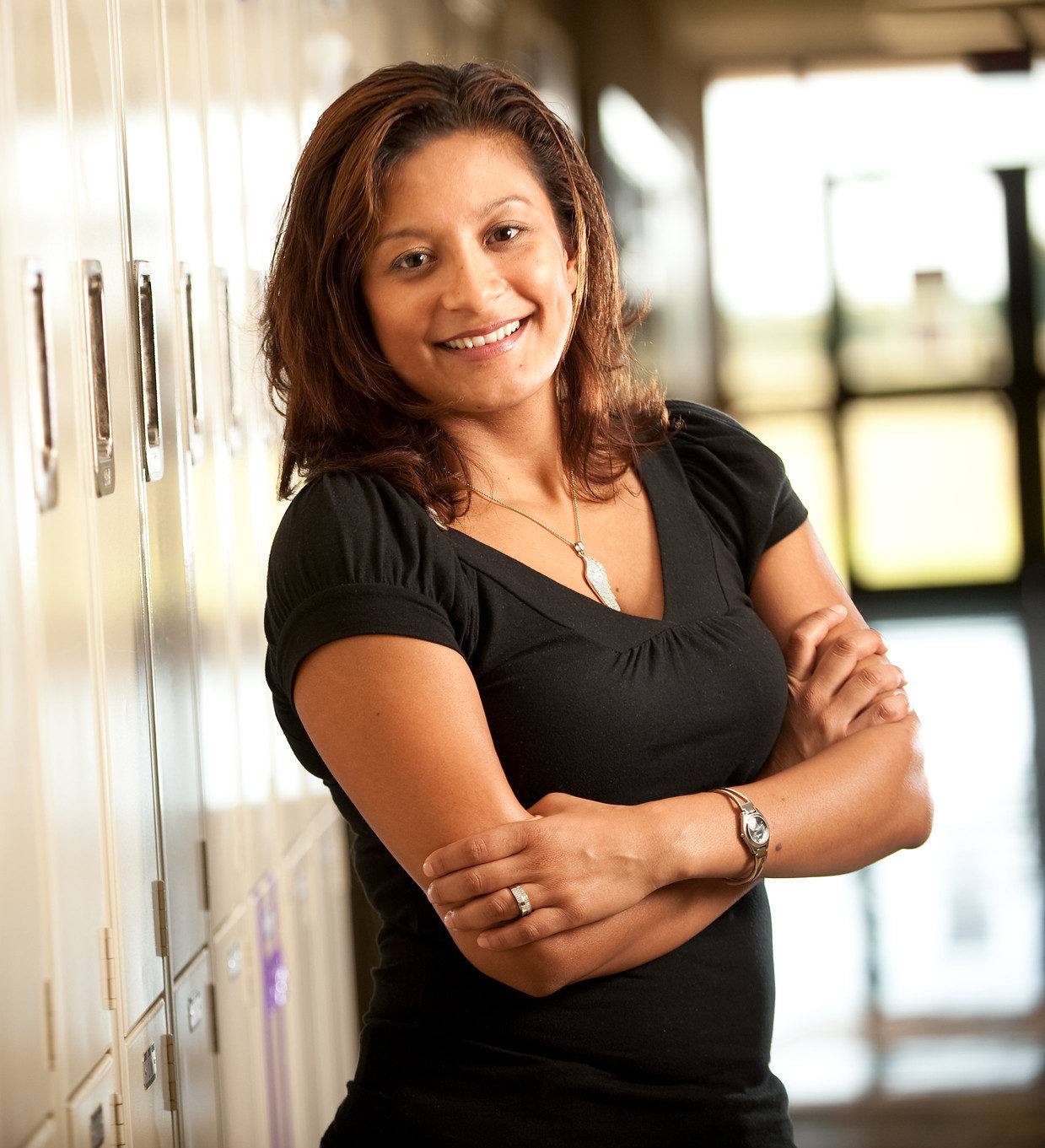 School counselors standing next to lockers.