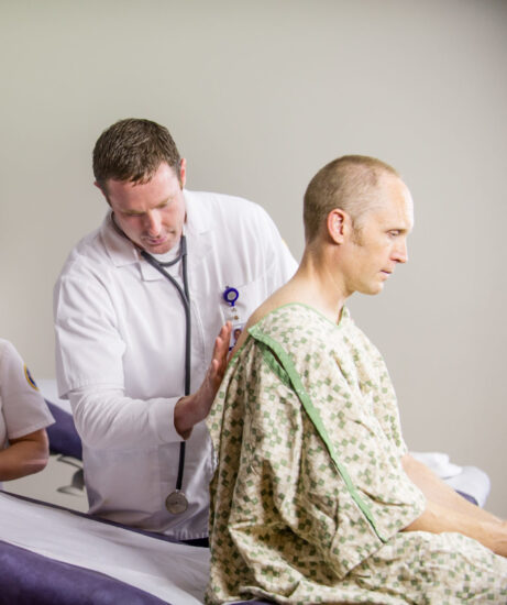 Nurse listening to patient breathing.