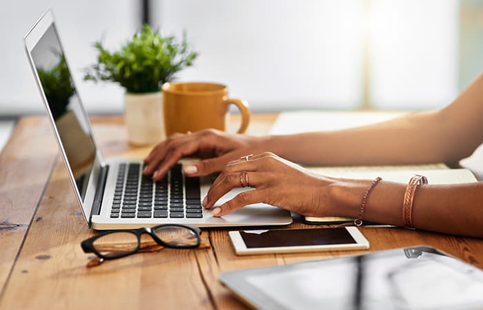 Shot of an unrecognizable woman working from home.