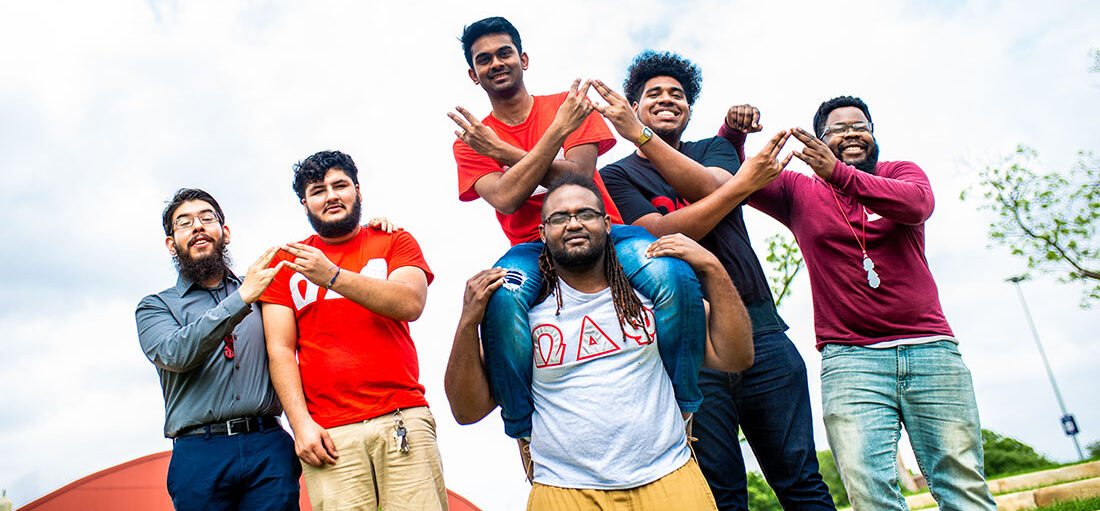 Group of students on a fraternity smiling at the camera.