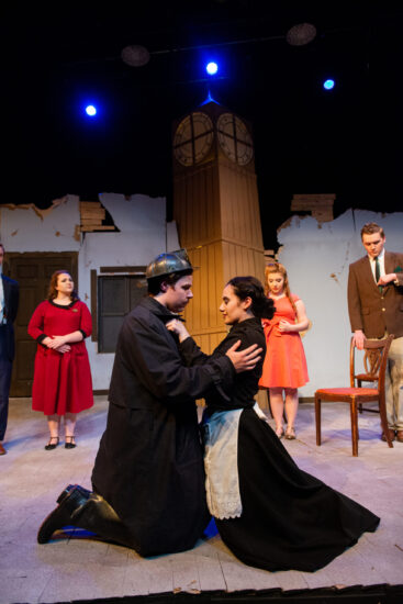 Theater performance with an actor and actress embracing.