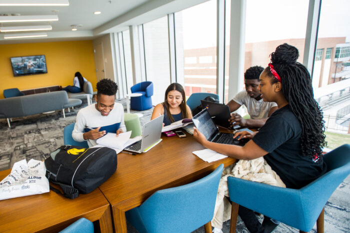 A group of students studying together sitting at a table.