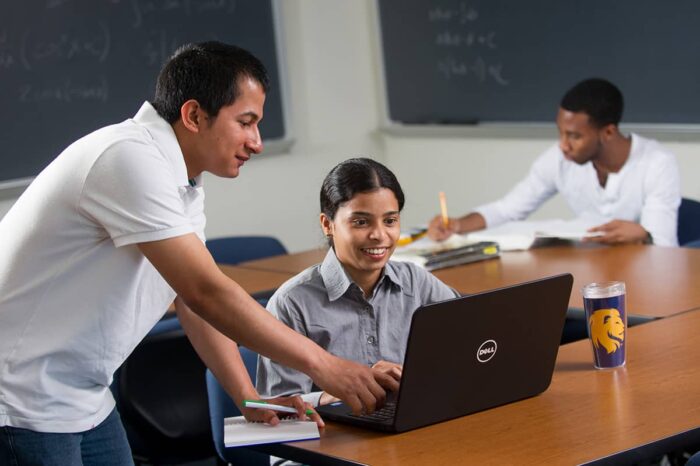 Student receiving help on the computer.