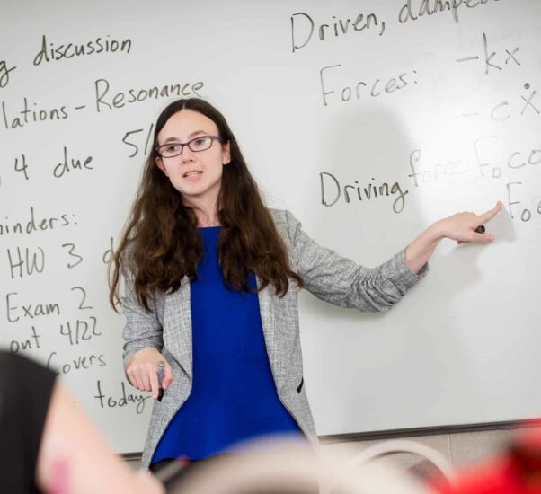 Professor actively engaged in a conversation with a student.