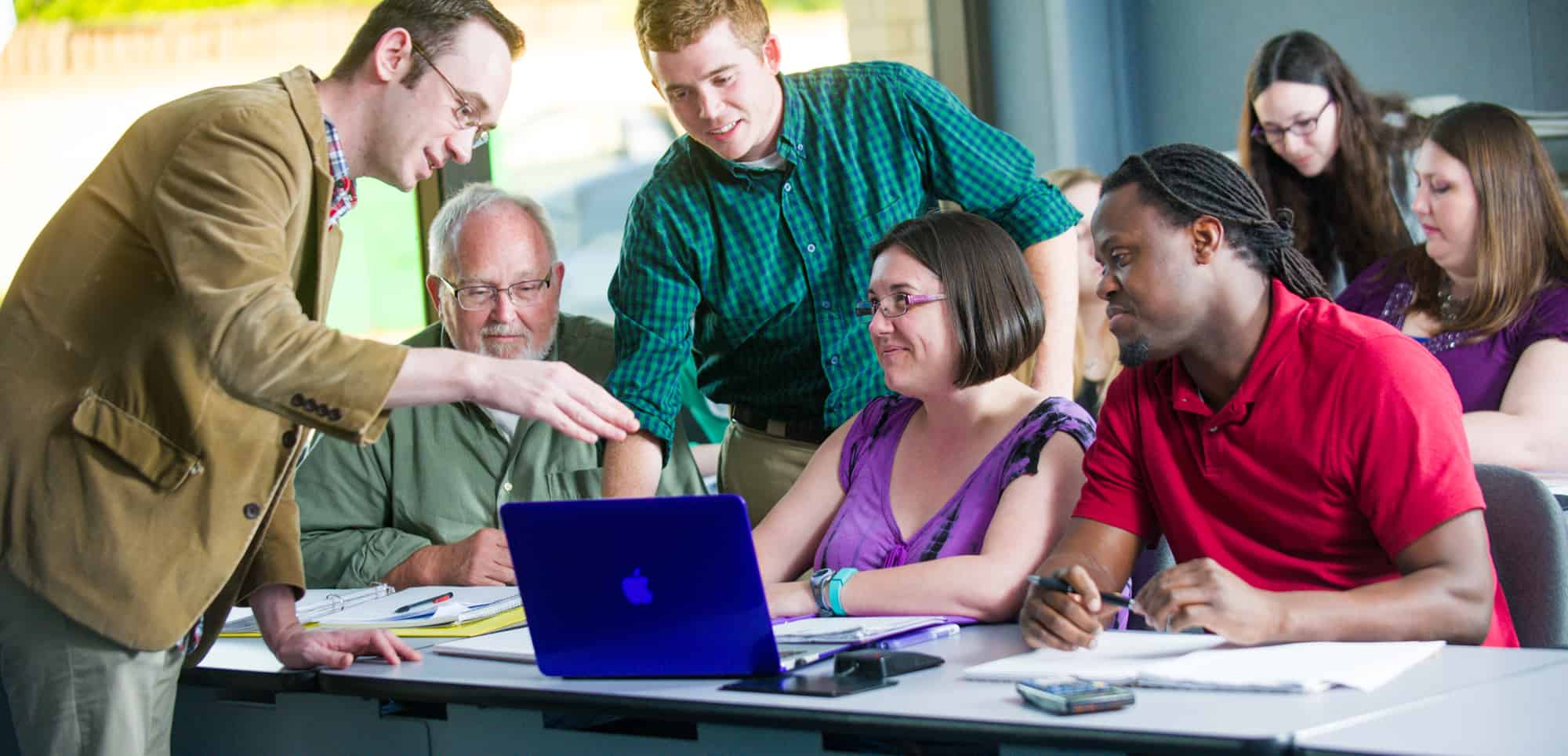 Professor actively engaged in a conversation with a student.