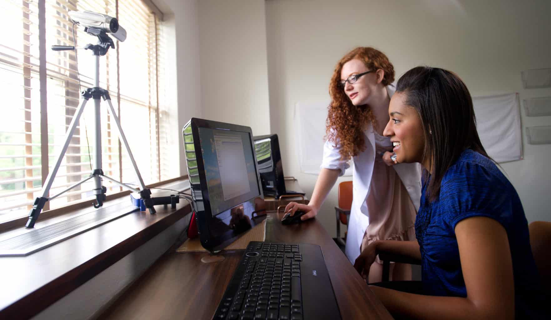 Psychology lab with two female students working at computer.