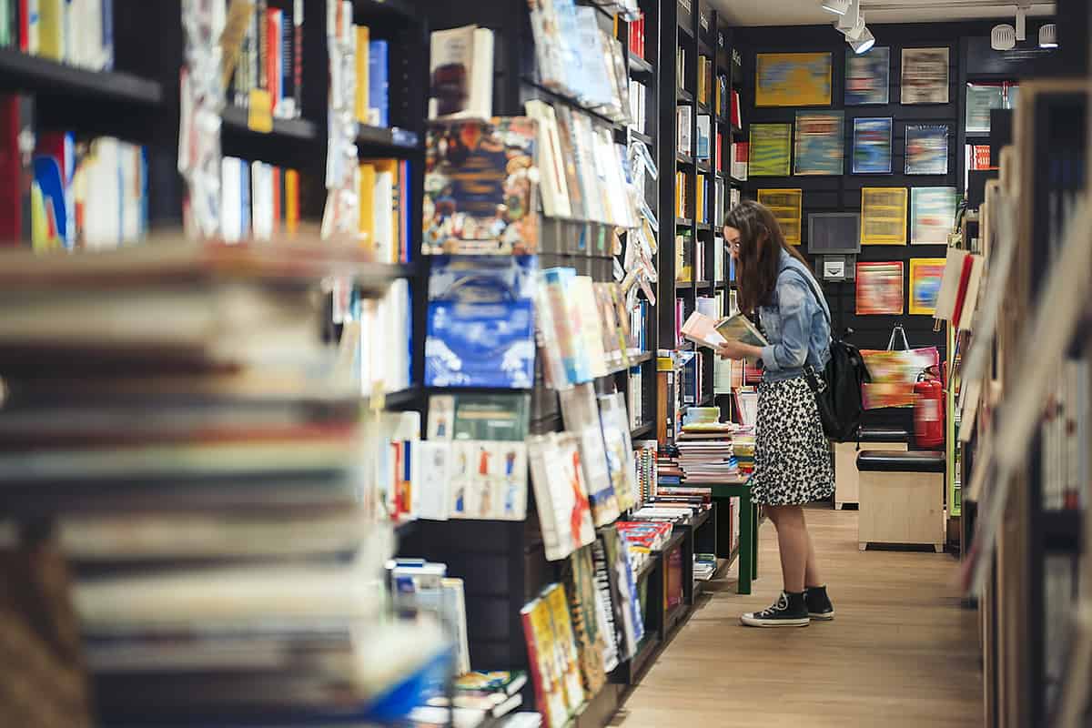 Female student searching for books in the book store.