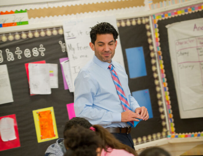 Male teacher in elementary classroom.