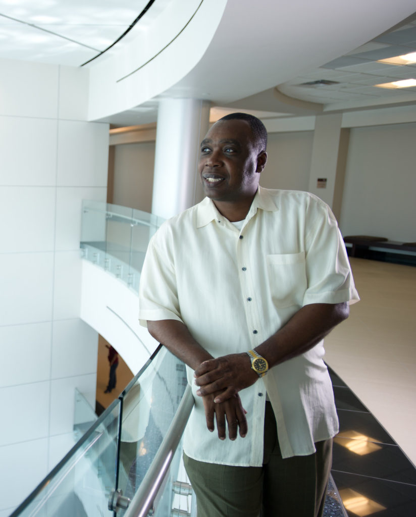 Male professor dress in a white button up shirt.