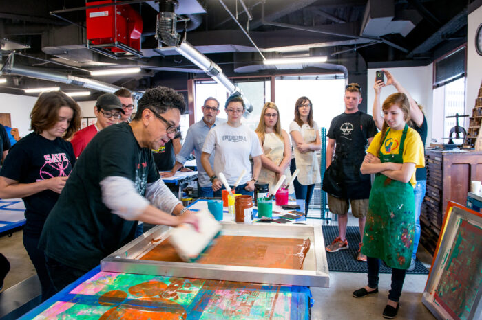 Professor actively engaged in a demonstration with students.