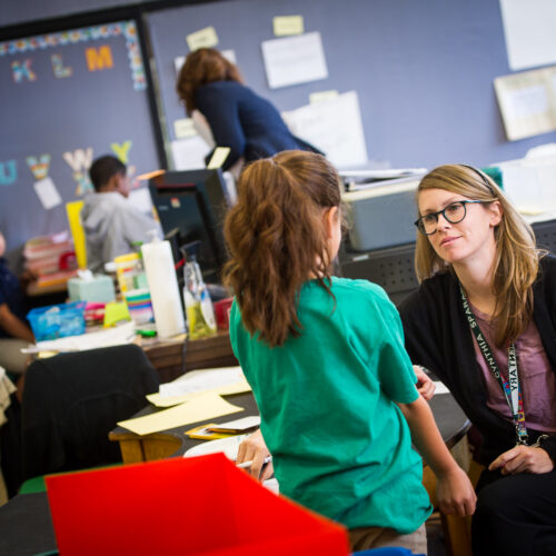 A teacher is listening to her student.