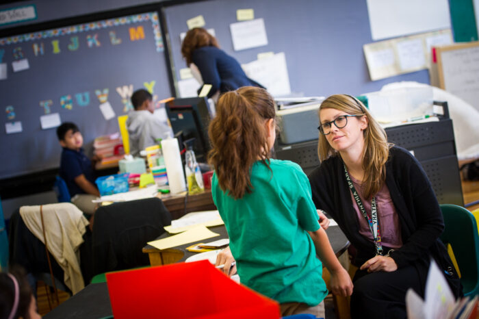 A teacher is listening to her student.