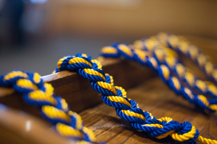 Blue and gold rope strung over a podium.