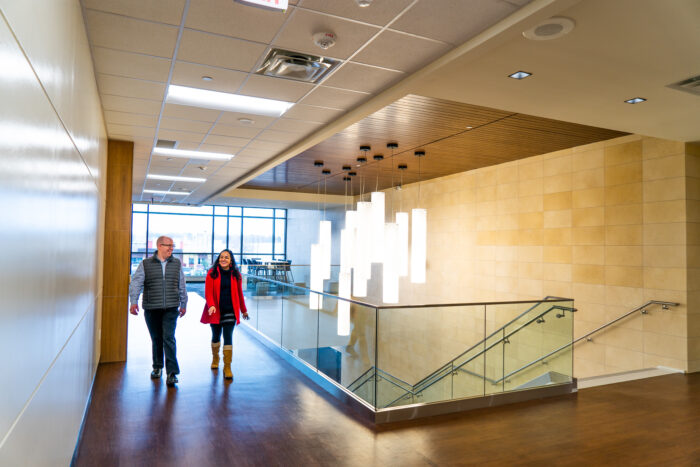 Two people walking inside the Mesquite Metroplex.