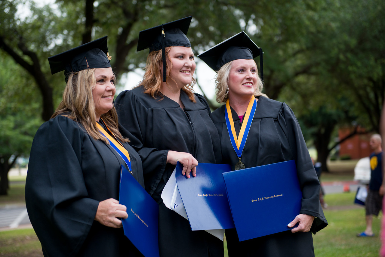 three female graduates talking a pitcure with their diplomas.