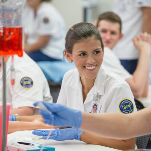 Nursing student smiling while learning.