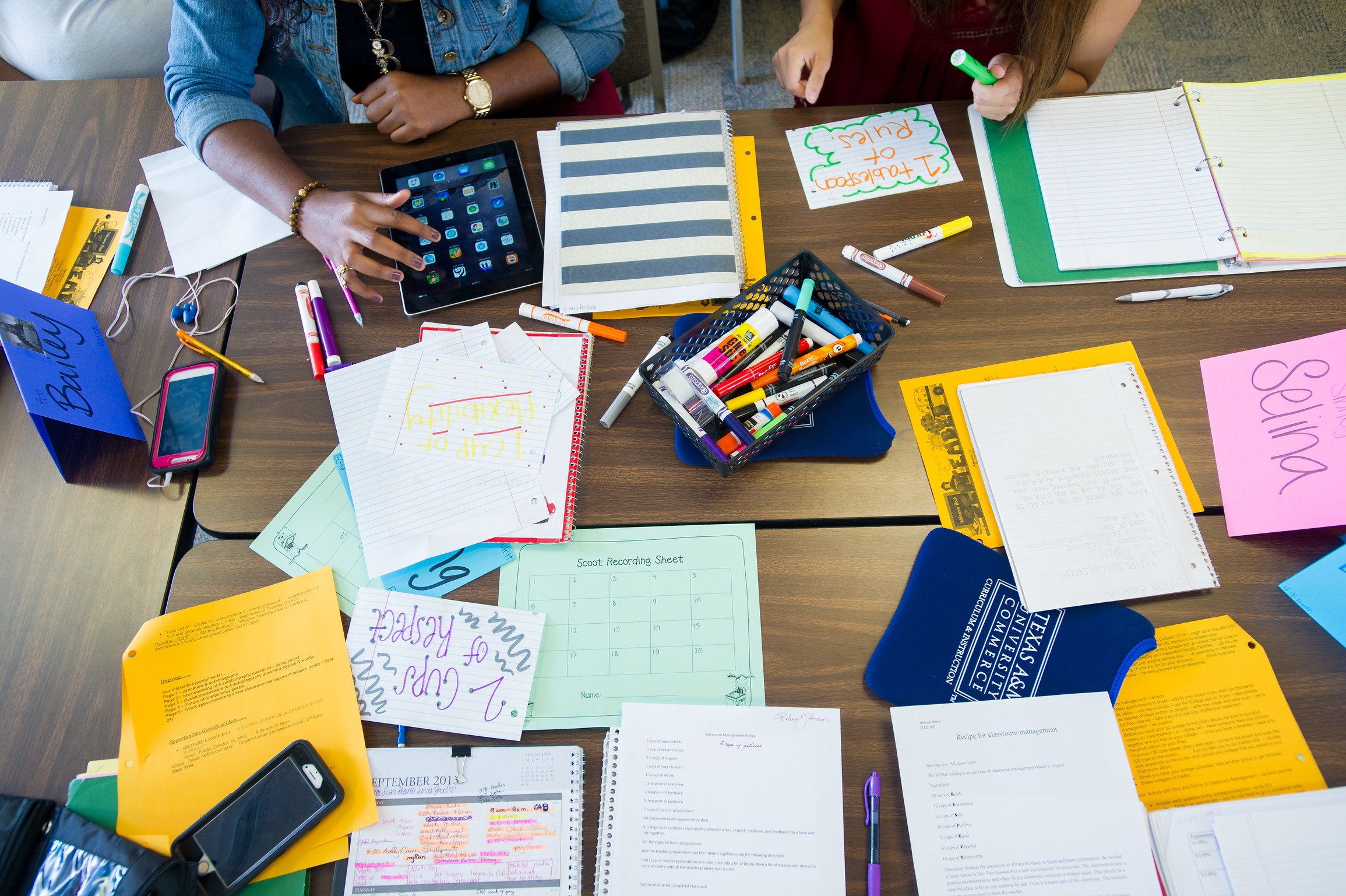 Desk with school supplies used by students.