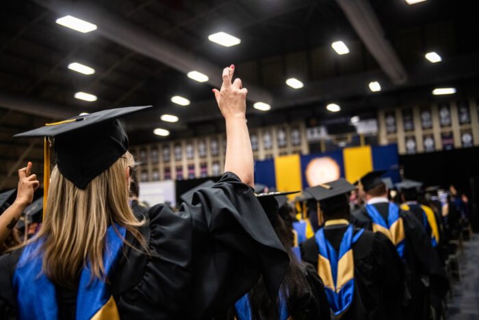 Students in their cap and gown during graduation.