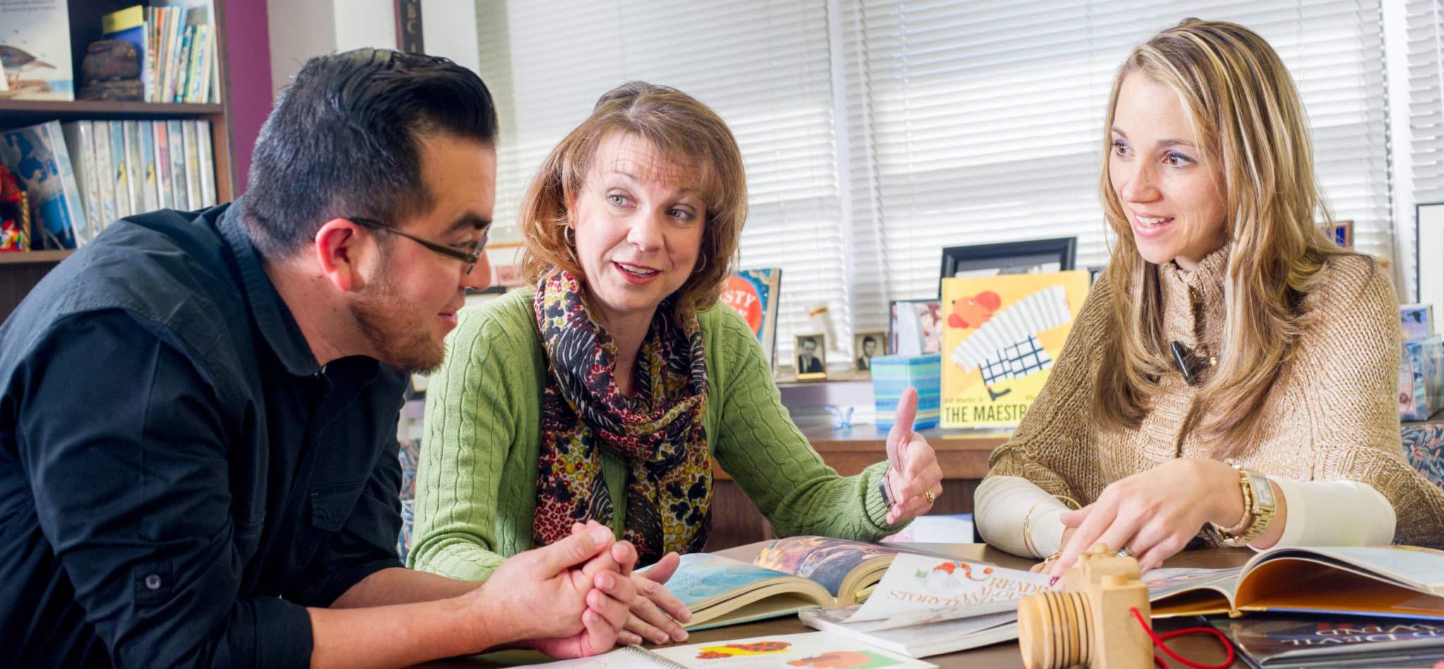 A student with two professors speaking about course material