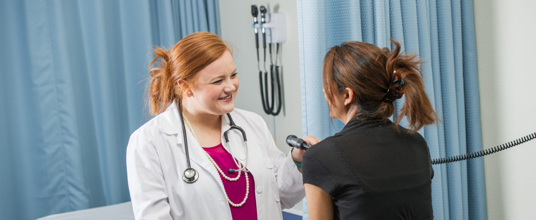 Health provider examining a patient.