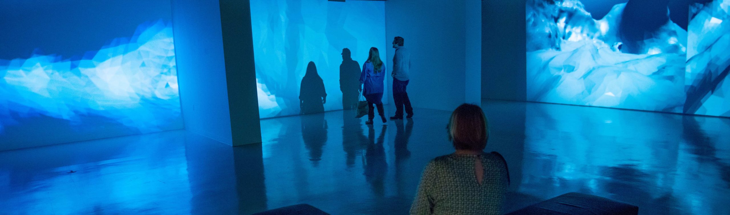 People viewing the university art gallery.