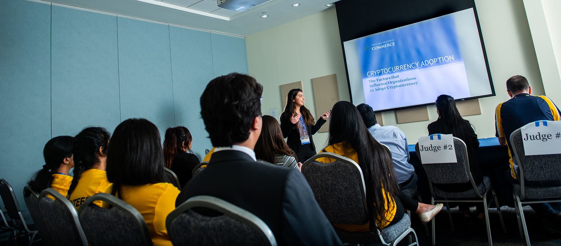 A group of students watching a presentation.