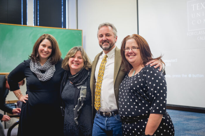 Group of professors standing in a classroom.