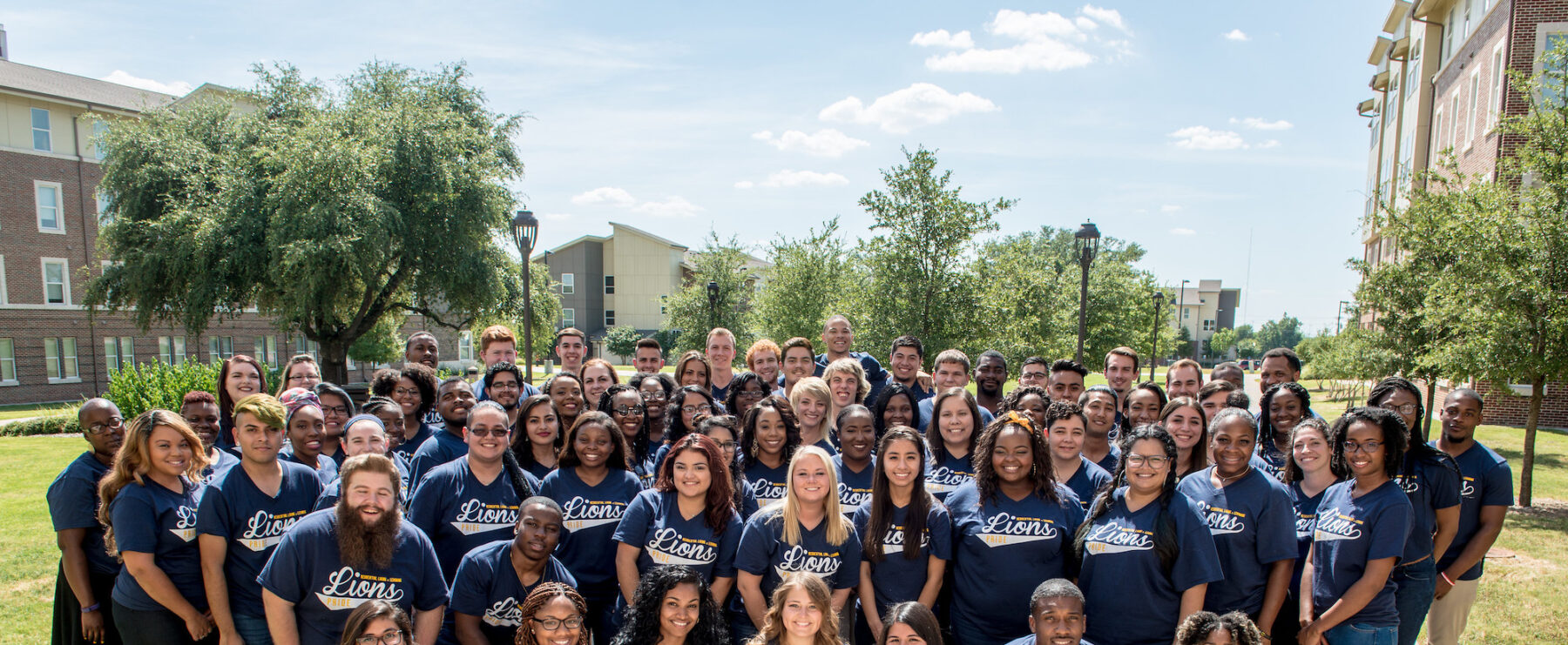 A group photo of TAMUC students wearing the same TAMUC blue shirt.