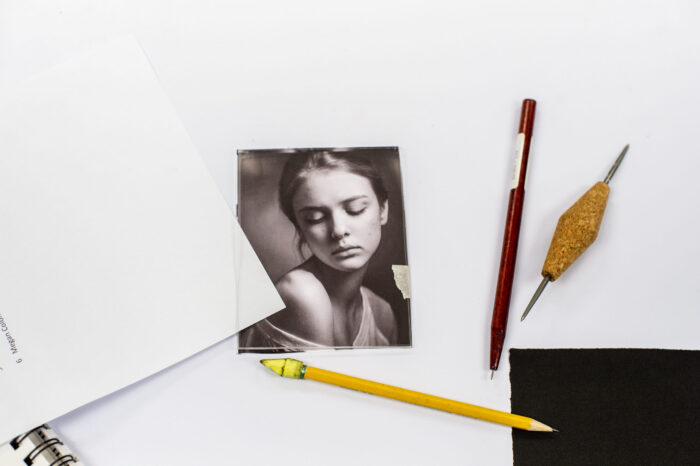 Photography portrait on table with art supplies.