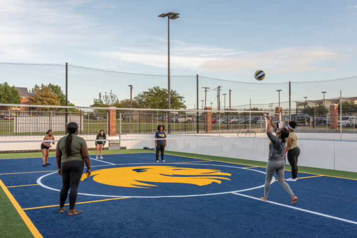 Students playing volleyball at the fields at the Morris Recreation Center.