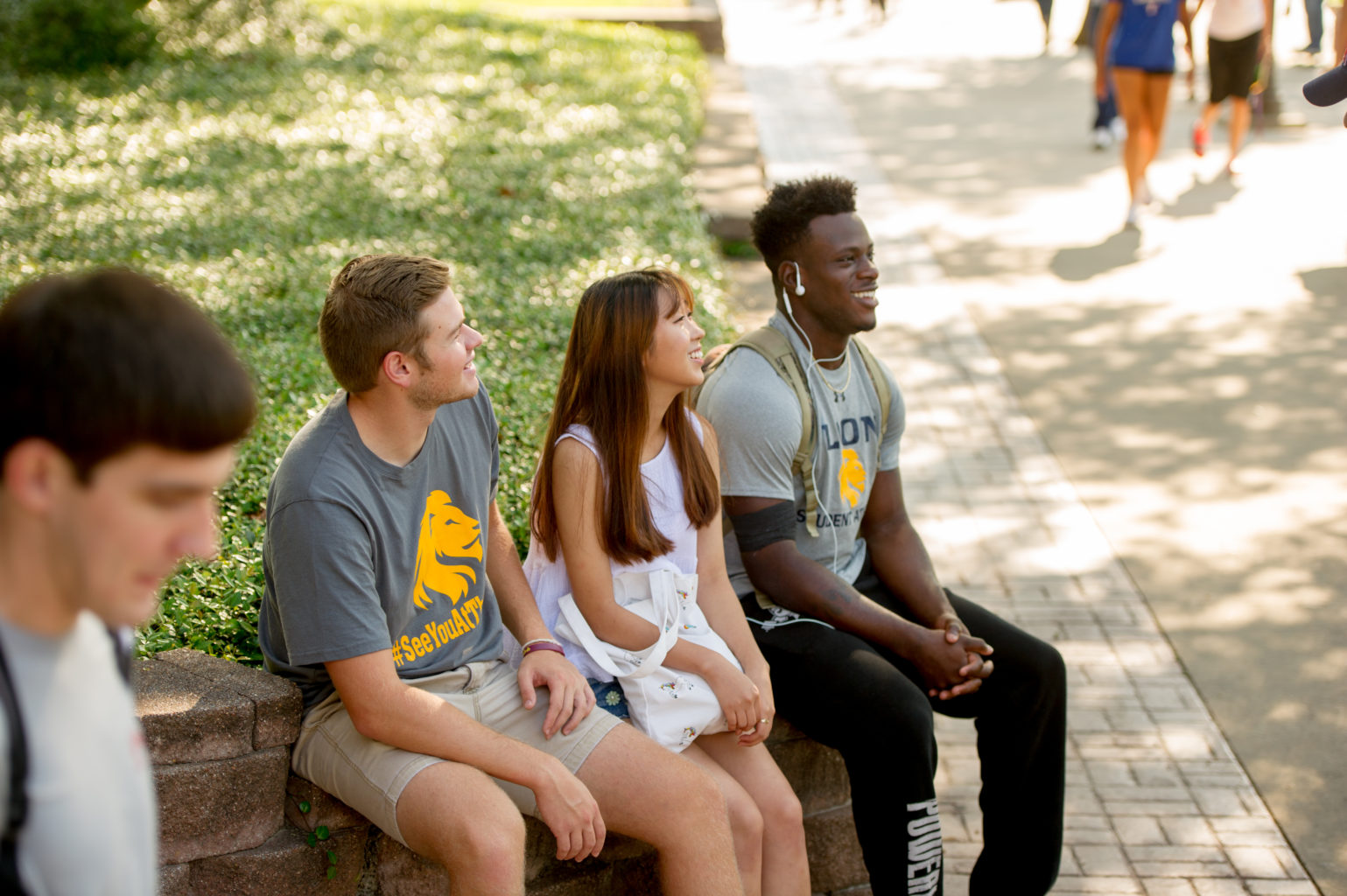 Group of students sitting on campus.